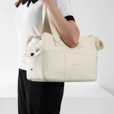 sac de transport en bandoulière de couleur beige avec son chien blanc